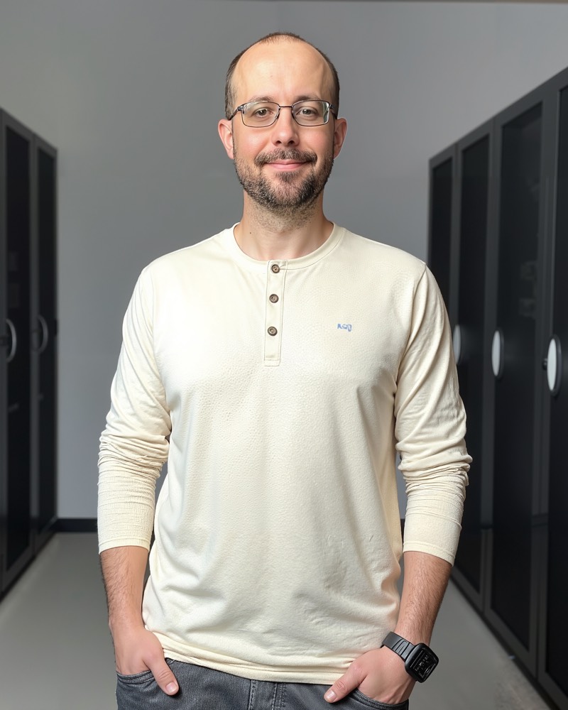Timothy Smith standing between server racks